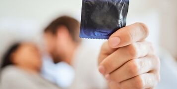Condom,,Safety,And,Safe,Sex,With,Couple,In,Bed,,Foreplay